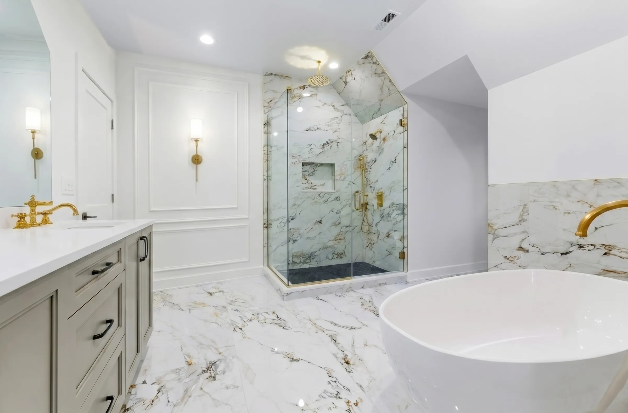 Marble master bath with a freestanding tub, brass fittings and a chandelier